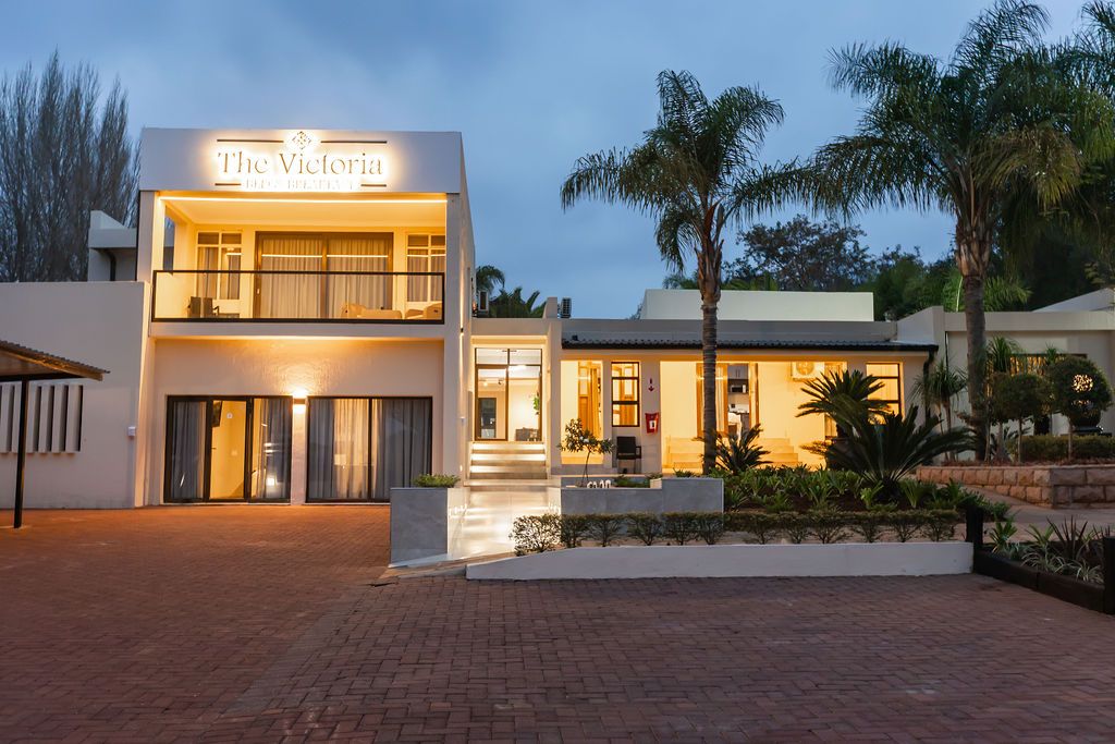The Victoria Bed & Breakfast building lit up at dusk in Newcastle